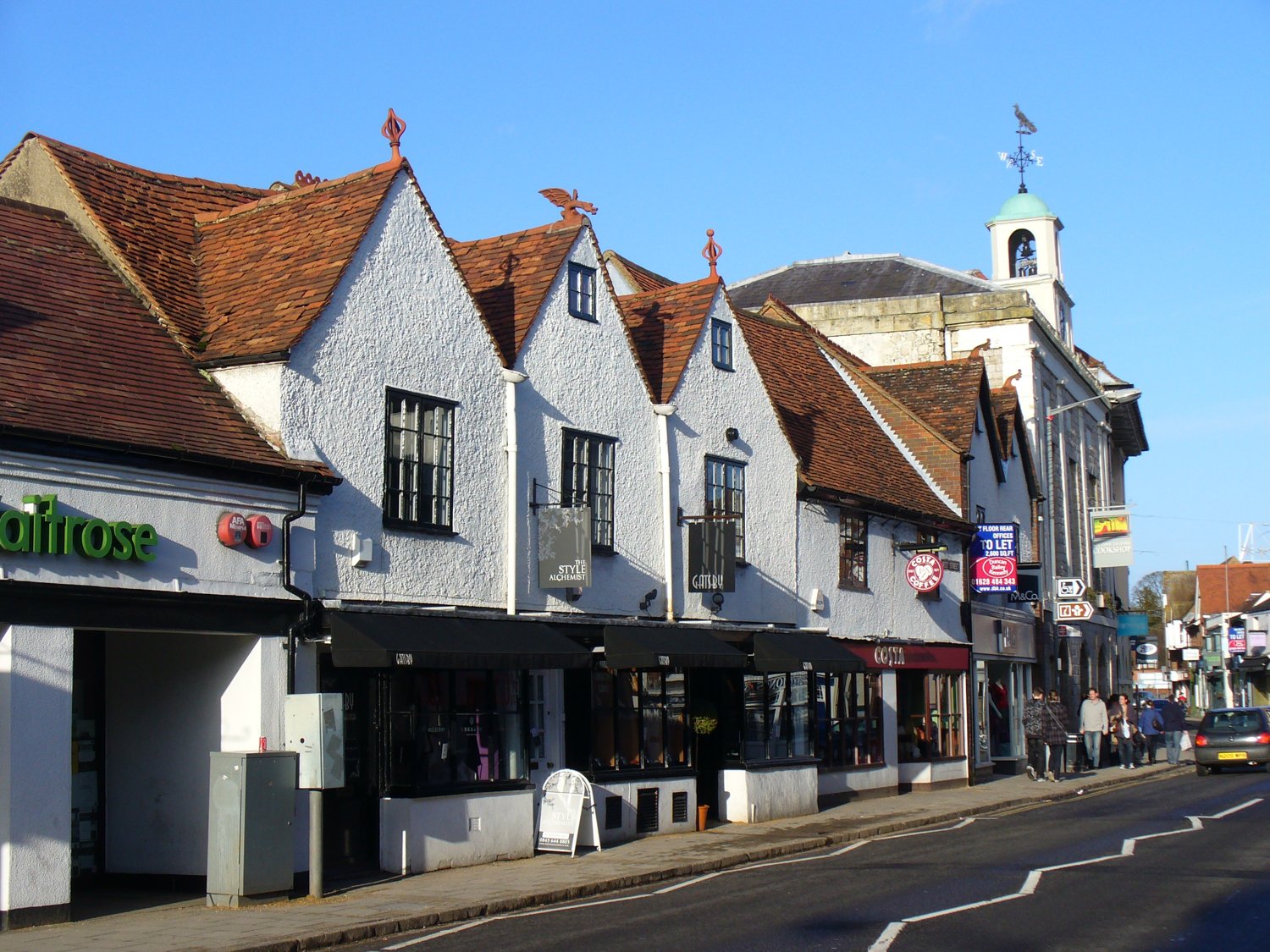 Marlow High Street shopfronts in winter sunshine, with the Georgian Town Hall beyond