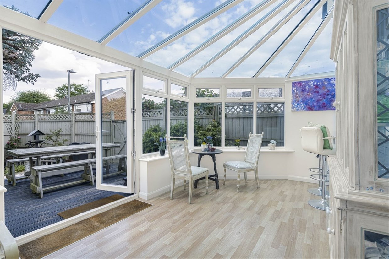 Large conservatory with underfloor heating opening to the deck