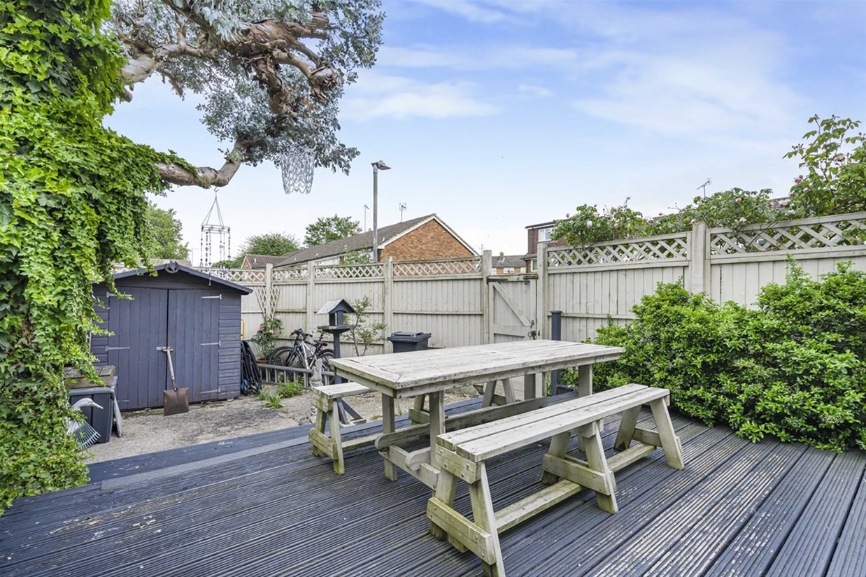 Low maintenance decked rear garden with mature planting